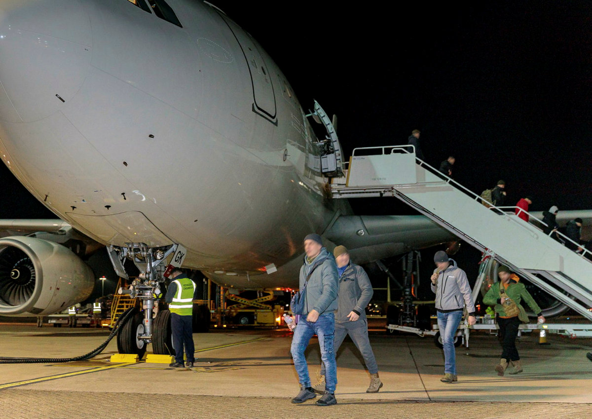 Image shows civilians departing RAF Voyager aircraft.